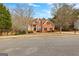 Attractive brick home with a well-maintained lawn on a sunny day at 510 Virginia Highlands, Fayetteville, GA 30215