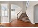 Inviting foyer with hardwood floors and a carpeted staircase leading to the upper level at 510 Virginia Highlands, Fayetteville, GA 30215
