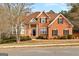 Charming brick home featuring a landscaped front yard, black shutters, and a classic architectural design at 510 Virginia Highlands, Fayetteville, GA 30215