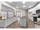 Open kitchen featuring granite counters, stainless appliances, white cabinets, and view to Gathering room at 510 Virginia Highlands, Fayetteville, GA 30215