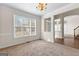 Well-lit living room with carpet flooring, large windows, and a view into the entry at 510 Virginia Highlands, Fayetteville, GA 30215