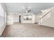 Open-concept living room with staircase access and a view into the adjacent kitchen at 510 Virginia Highlands, Fayetteville, GA 30215