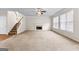 Large living room featuring a cozy fireplace and staircase, offering both comfort and style at 510 Virginia Highlands, Fayetteville, GA 30215