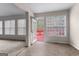 Living room with windows overlooking the backyard and a doorway leading to an outdoor deck at 510 Virginia Highlands, Fayetteville, GA 30215