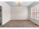 Empty formal dining room features carpet flooring, white trim, and a classic chandelier at 510 Virginia Highlands, Fayetteville, GA 30215