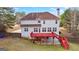 The back of the house features a red deck, walkout basement and neutral vinyl siding at 510 Virginia Highlands, Fayetteville, GA 30215