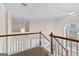 Carpeted staircase with white railing and view to foyer at 510 Virginia Highlands, Fayetteville, GA 30215