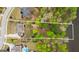 Aerial view of large lot featuring a fire pit, lush landscaping, and wooded area leading up to the water at 157 Waterlace Way, Fayetteville, GA 30215