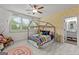 Bright bedroom with a decorative bed frame, patterned wallpaper, and ample natural light at 157 Waterlace Way, Fayetteville, GA 30215
