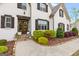 Charming white brick home featuring a stained wood double door entry, wood shutters and landscaped front yard at 157 Waterlace Way, Fayetteville, GA 30215