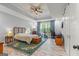 Spacious primary bedroom with a tray ceiling, work space, and a large window at 157 Waterlace Way, Fayetteville, GA 30215