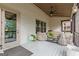 Relaxing screened porch with wood ceiling, ceiling fan, and furniture with protective covers at 157 Waterlace Way, Fayetteville, GA 30215