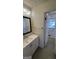 Neat bathroom featuring a new vanity and a large mirror at 220 Cabriolet Trl, Mcdonough, GA 30253