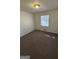Cozy bedroom with plush carpeting and a large window at 220 Cabriolet Trl, Mcdonough, GA 30253