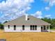The backyard features a well-maintained lawn and partial view of a bright sky with white clouds at 4139 Alayna Lee Cir, Mcdonough, GA 30252