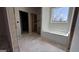 Under-construction bathroom featuring a soaker tub under a window with natural light at 4139 Alayna Lee Cir, Mcdonough, GA 30252