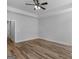 Bright bedroom features a ceiling fan, wood-look floors and white trim and doors at 4139 Alayna Lee Cir, Mcdonough, GA 30252