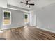 Spacious bedroom featuring tray ceiling, ceiling fan and wood-look flooring at 4139 Alayna Lee Cir, Mcdonough, GA 30252