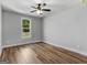 Bright and spacious bedroom features hardwood floors, natural light, and a ceiling fan at 4139 Alayna Lee Cir, Mcdonough, GA 30252