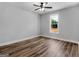 Bright bedroom features a ceiling fan, wood-look floors and a window to the yard at 4139 Alayna Lee Cir, Mcdonough, GA 30252