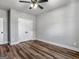 Bedroom features a ceiling fan, wood-look floors and a double-door closet at 4139 Alayna Lee Cir, Mcdonough, GA 30252