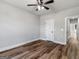 Bright bedroom features a ceiling fan, wood-look floors and white trim and doors at 4139 Alayna Lee Cir, Mcdonough, GA 30252