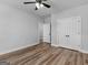Bedroom features a ceiling fan, wood-look floors and access to a closet at 4139 Alayna Lee Cir, Mcdonough, GA 30252