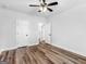 Bright bedroom features a ceiling fan, wood-look floors and white trim and doors at 4139 Alayna Lee Cir, Mcdonough, GA 30252