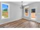 Bright dining room with hardwood floors, natural light, and views of the landscaped backyard at 4139 Alayna Lee Cir, Mcdonough, GA 30252
