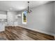 Spacious dining area features hardwood flooring, a modern chandelier, and easy access to the kitchen at 4139 Alayna Lee Cir, Mcdonough, GA 30252