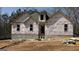 Unfinished exterior view of a single-Gathering home under construction with visible building materials at 4139 Alayna Lee Cir, Mcdonough, GA 30252