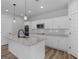 Bright, open kitchen features a large island with granite countertops, stainless steel appliances, and white cabinetry at 4139 Alayna Lee Cir, Mcdonough, GA 30252