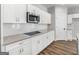 Modern kitchen featuring granite countertops, subway tile, stainless steel appliances, and white cabinets at 4139 Alayna Lee Cir, Mcdonough, GA 30252