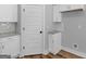 Well-lit kitchen showcases white cabinets, granite countertops, subway tile backsplash, and modern finishes at 4139 Alayna Lee Cir, Mcdonough, GA 30252