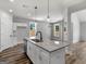 Modern kitchen featuring granite counters, an island, and stainless steel appliances in an open-concept space at 4139 Alayna Lee Cir, Mcdonough, GA 30252