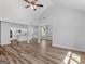 Open concept living room and kitchen area featuring wood floors, white cabinets and columns at 4139 Alayna Lee Cir, Mcdonough, GA 30252