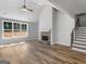 Bright living room with wood floors, stone fireplace, vaulted ceilings, large windows and staircase at 4139 Alayna Lee Cir, Mcdonough, GA 30252