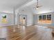 Spacious living room with vaulted ceiling, wood-look floors, white columns, and large windows at 4139 Alayna Lee Cir, Mcdonough, GA 30252