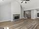 Spacious living room featuring a stone fireplace, vaulted ceilings, wood floors and a staircase at 4139 Alayna Lee Cir, Mcdonough, GA 30252