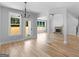 Open concept living room with natural light, hardwood floors, fireplace, and backyard views at 4139 Alayna Lee Cir, Mcdonough, GA 30252