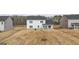 Backyard view of a two-story home and an expansive grass lawn at 1712 Goodwin Dr, Hampton, GA 30228