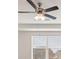 A close up view of a ceiling fan with lights illuminating from the ceiling at 1712 Goodwin Dr, Hampton, GA 30228