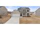 Charming two-story brick home with a two-car garage and manicured lawn on a sunny day at 1712 Goodwin Dr, Hampton, GA 30228