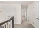 Bright hallway featuring neutral carpet, white walls, and access to multiple rooms at 1712 Goodwin Dr, Hampton, GA 30228