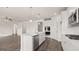 Bright kitchen boasts stainless steel appliances, a large island with a sink, and modern lighting fixtures at 1712 Goodwin Dr, Hampton, GA 30228