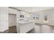 Bright kitchen featuring an island, white cabinets, stainless steel appliances, and hardwood floors at 1712 Goodwin Dr, Hampton, GA 30228