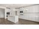 Modern kitchen featuring stainless steel appliances, white cabinets, a center island, and hardwood floors at 1712 Goodwin Dr, Hampton, GA 30228