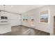 Eat-in kitchen features an island, white cabinets, and is adjacent to a dining area with windows and backyard access at 1712 Goodwin Dr, Hampton, GA 30228
