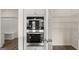 Gourmet kitchen appliances next to an open pantry with organized shelving at 1712 Goodwin Dr, Hampton, GA 30228