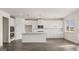 Open-concept kitchen with white cabinets, a large island, stainless steel appliances, and hardwood floors at 1712 Goodwin Dr, Hampton, GA 30228